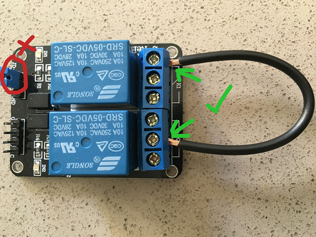 Relay board with loop wire connecting the two relays